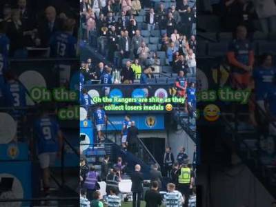 Celtic fans taunt Rangers players as they collect losers medals