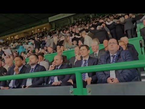 Celtic Fans Do The Huddle In Front Of Depressed Looking Rangers Board