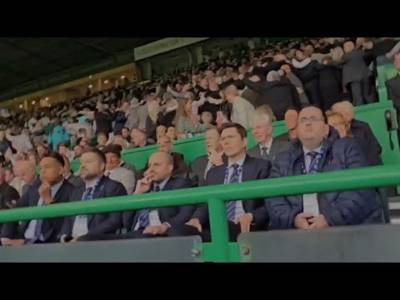 Celtic Fans Do The Huddle In Front Of Depressed Looking Rangers Board