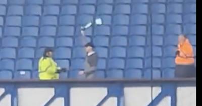 Celtic fan invades Rangers end as rogue punter huckled by stewards after breaking cover and waving scarf