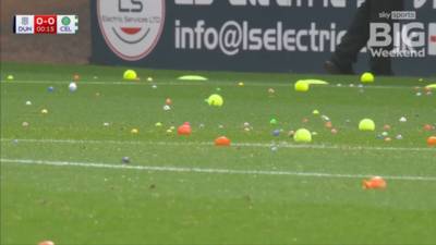 Raging Celtic fans cause delay in game against Dundee by throwing BALLS and ORANGES onto pitch in latest board protest