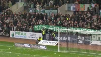 Raging Celtic fans hurl tennis balls and oranges onto the pitch as they delay start of game at Dundee with furious protest against the board