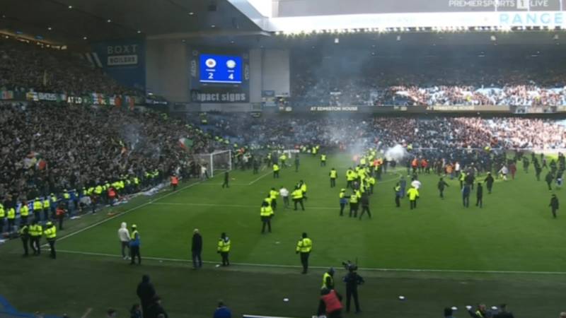 Wild moment hundreds of Rangers and Celtic fans storm onto Ibrox pitch to confront each other and lob FIREWORKS