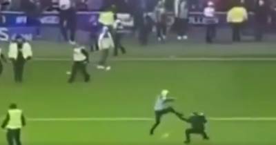 Fan floored in shocking ‘kick’ assault during Rangers v Celtic pitch invasion chaos