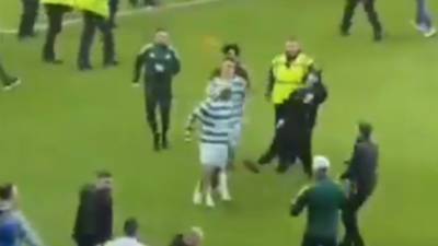 Moment Rangers fan attempts to kick Celtic star on pitch as chaos erupts after O** F*** showdown at Ibrox