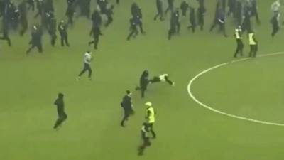 Shock moment Rangers fan KICKS police officer to the ground amid O** F*** carnage