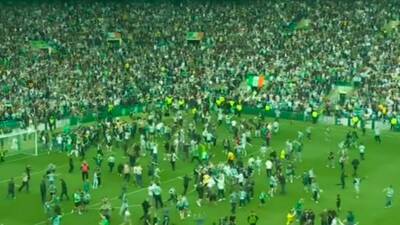 Celtic clinch title amid CHAOTIC scenes after wild pitch invasion before final whistle as Hearts left broken