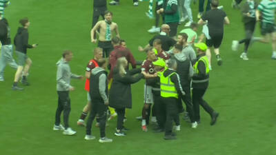 Shock moment Hearts star Lawrence Shankland clashes with Celtic fan as pitch invasion turns ugly