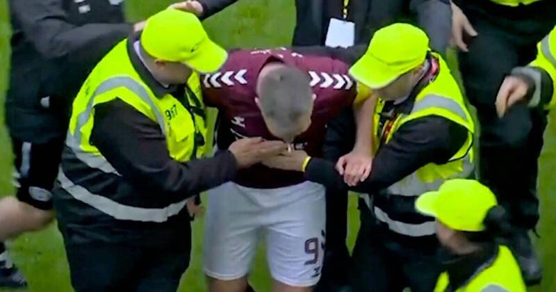 Hearts star ‘punched by fan’ in pitch invasion as Celtic blasted for shameful scenes
