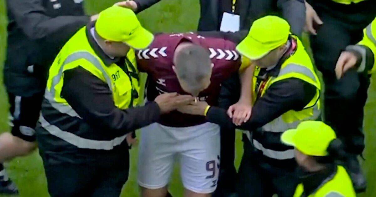 Hearts star ‘punched by fan’ in pitch invasion as Celtic blasted for shameful scenes