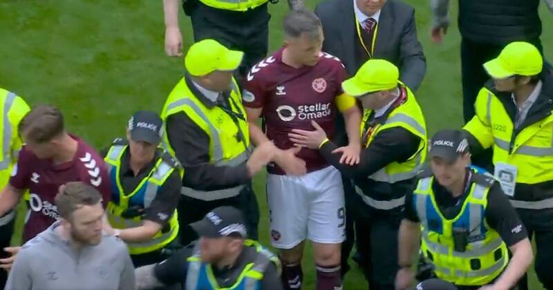 BREAKING: Celtic vs Hearts ends in ugly scenes as police drag players off after pitch invasion