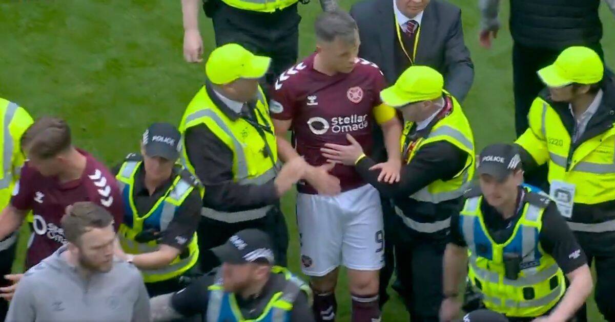 BREAKING: Celtic vs Hearts ends in ugly scenes as police drag players off after pitch invasion