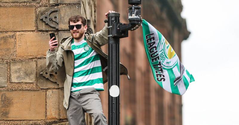 Celtic fans swarm Glasgow Trongate and climb traffic lights as league party kicks off