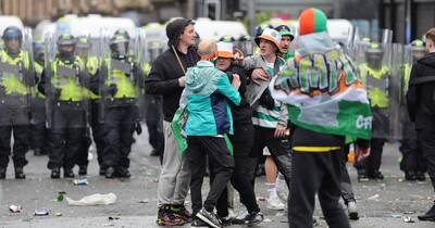 Celtic fans pelt riot police with bottles as fights break out in Glasgow